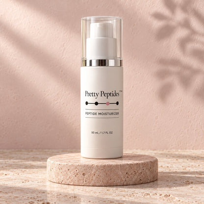 Pretty Peptides Peptide Moisturizer, 50 ml pump bottle on a travertine riser against a blush plaster wall
