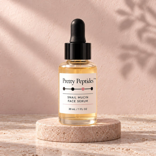 Pretty Peptides Snail Mucin Face Serum, 30 ml dropper bottle on a travertine riser against a blush plaster wall