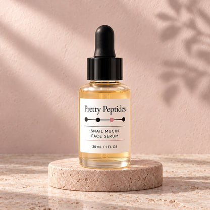 Pretty Peptides Snail Mucin Face Serum, 30 ml dropper bottle on a travertine riser against a blush plaster wall